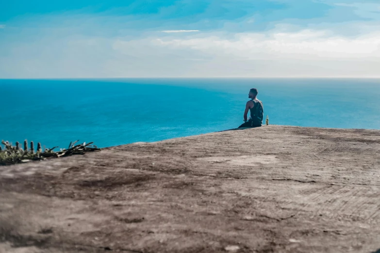 a person sitting on top of a large hill