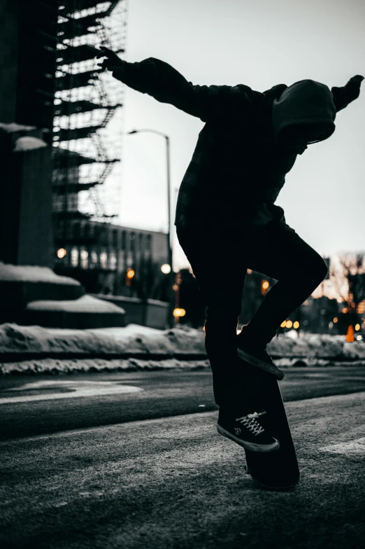 a young man riding his skateboard at night