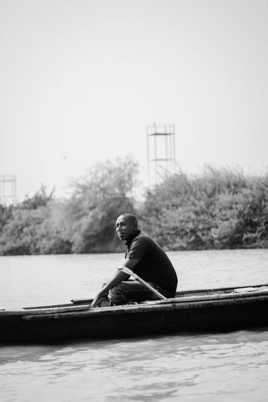 man in a boat with oars on the river