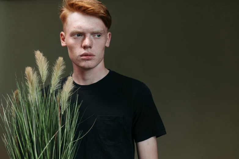 an image of a man standing in front of a plant