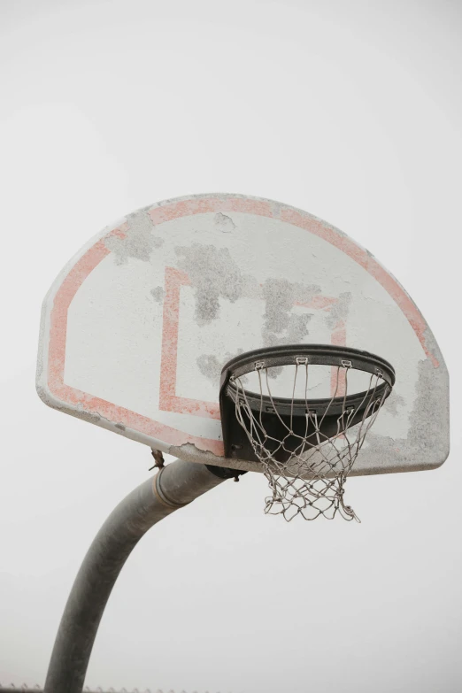 a basketball hoop on the back of an old ball court