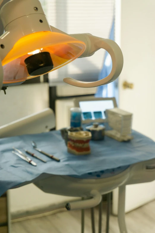 a medical lamp is lit up above an examination room