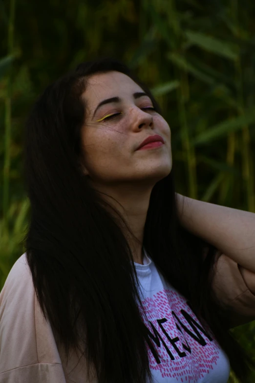 a woman is looking up while wearing a t - shirt