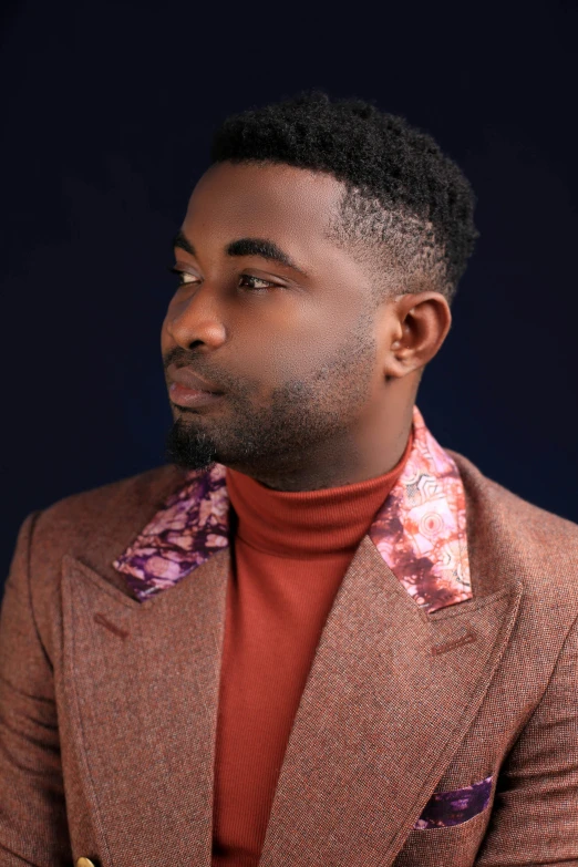 a man in a brown jacket and flowered scarf