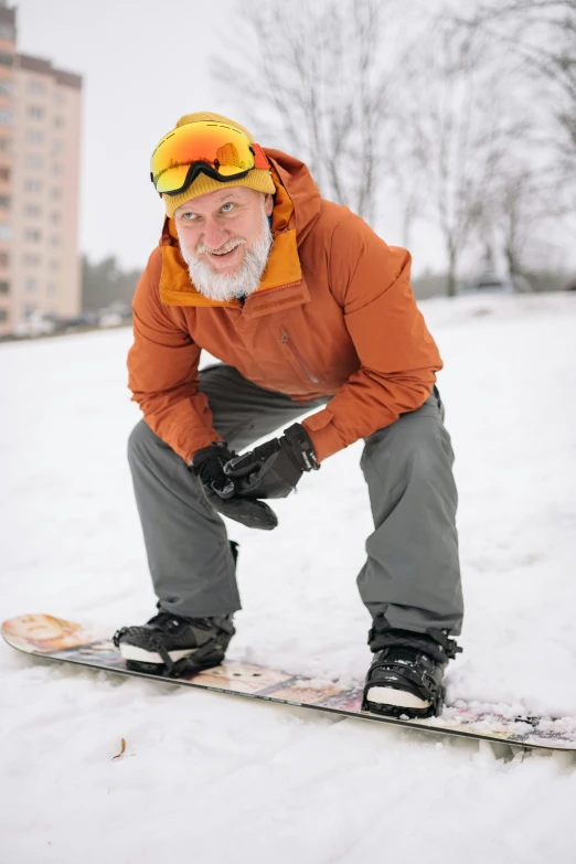 a man riding skis on top of snow covered ground
