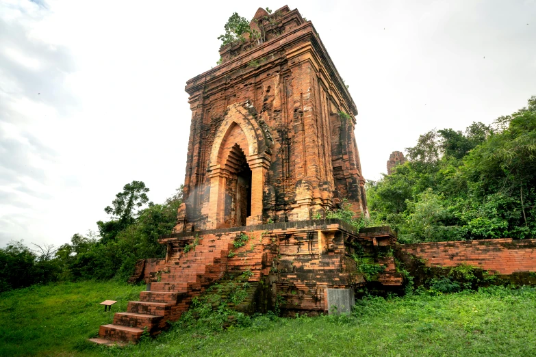 an old stone tower is in the middle of the forest