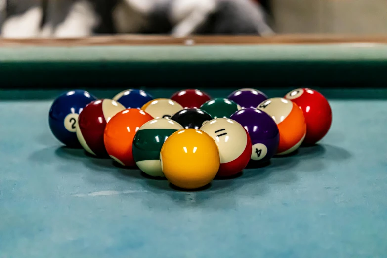 eight ball in different colors and sizes on a pool table