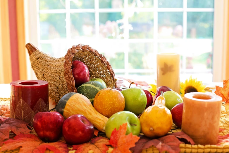 a wooden candle is sitting next to some fruit