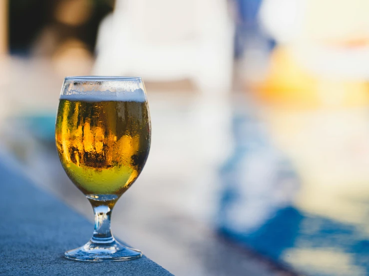 a beer glass that has been placed outside on a table