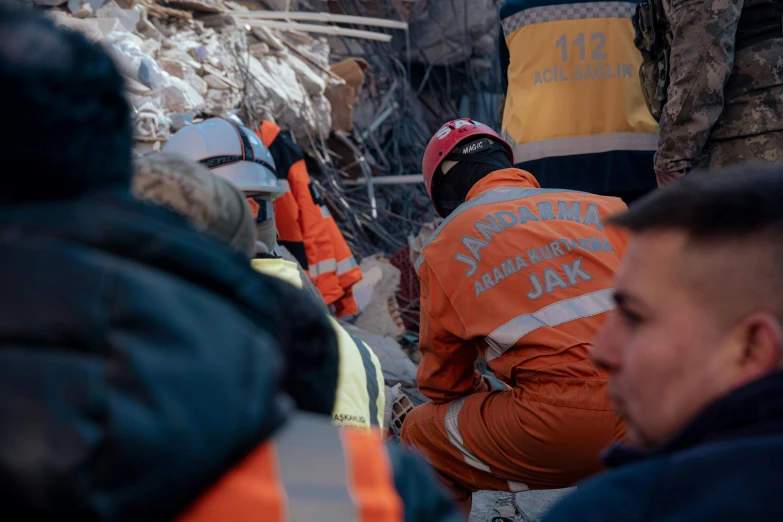 a group of people wearing jackets and vests and working