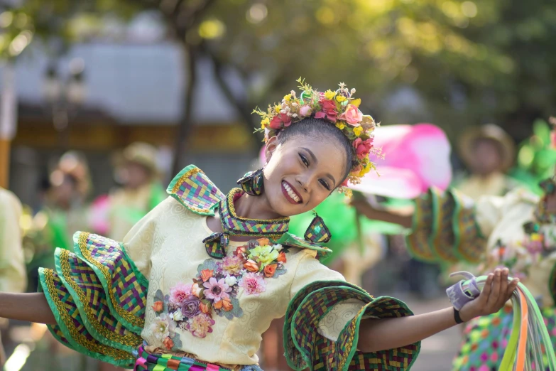 woman in native dress performing in parade with spectators