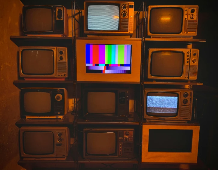 a pile of tvs that have different color and pattern designs