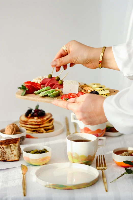 a person putting a slice of fruit on a toast board