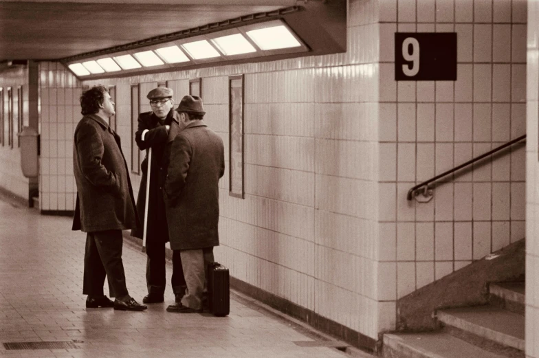 men stand on the stairs talking to each other