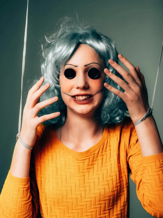 a woman with makeup on holding her head