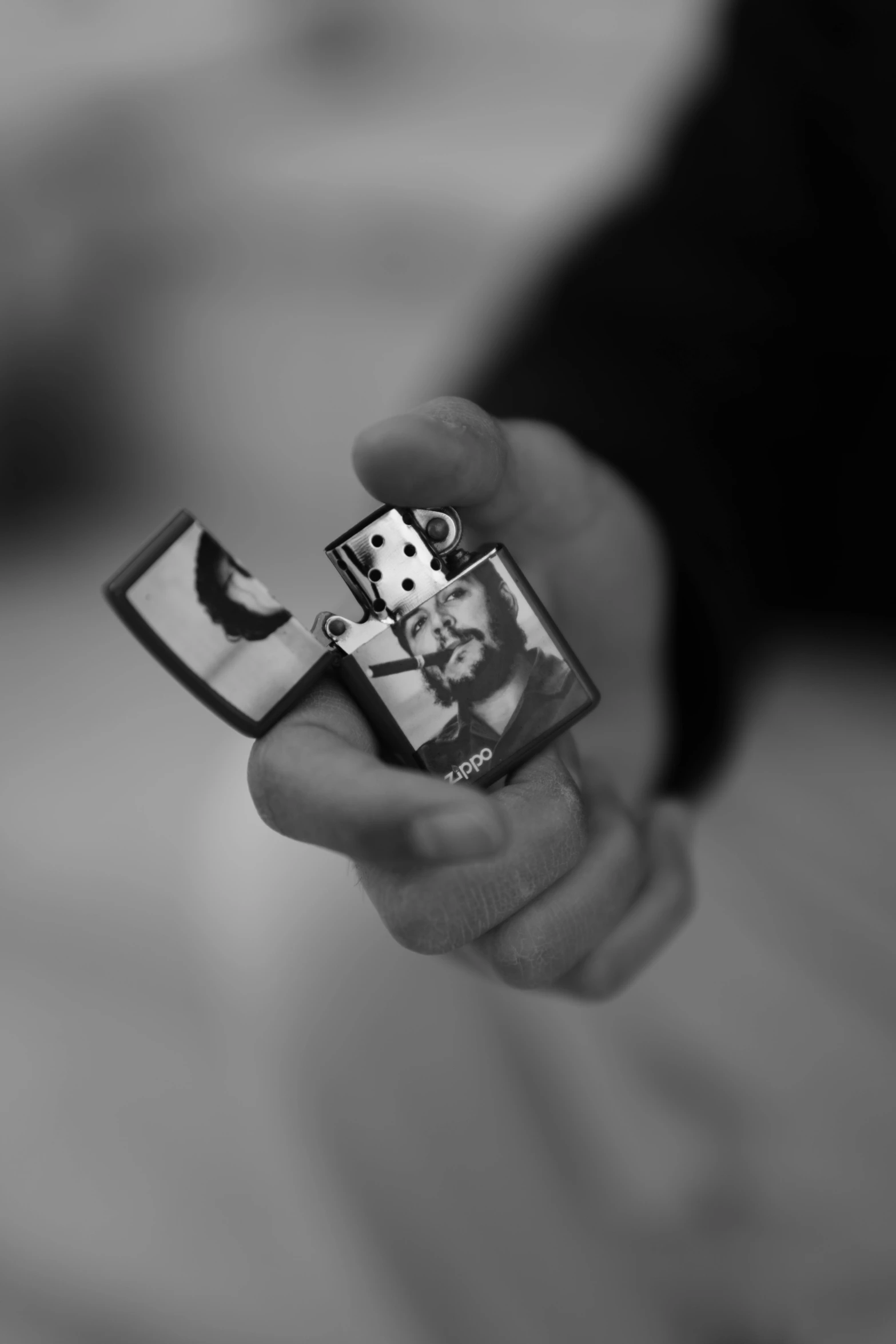 black and white pograph of a person holding a lighter