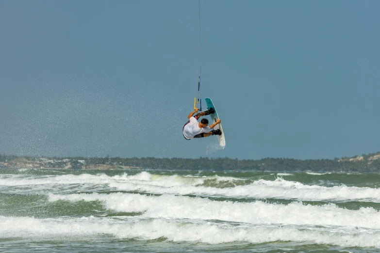 a person in the air on a wind surfboard