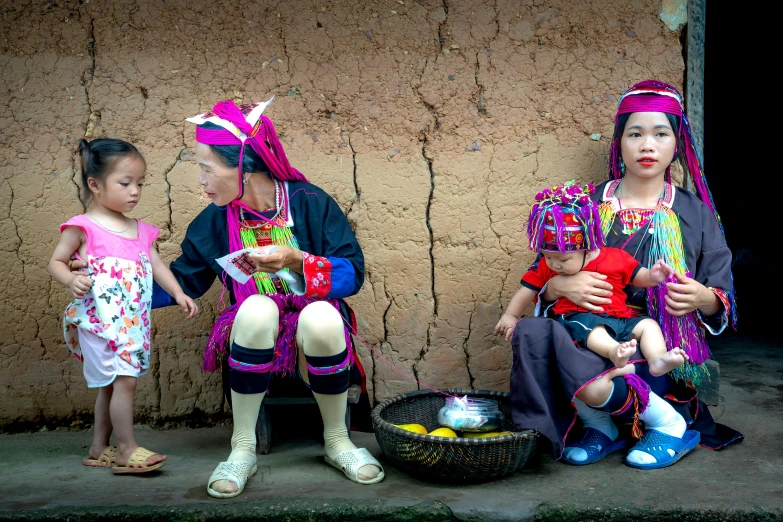 a woman and two girls holding their baby dolls