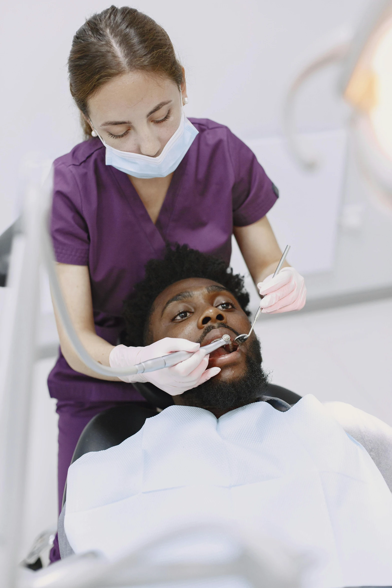 a smiling woman sitting next to a male patient