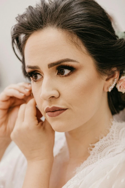 a woman holding her hair to the side