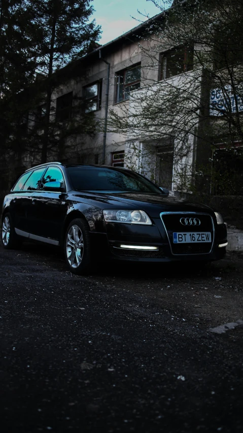 a black car parked in front of a building