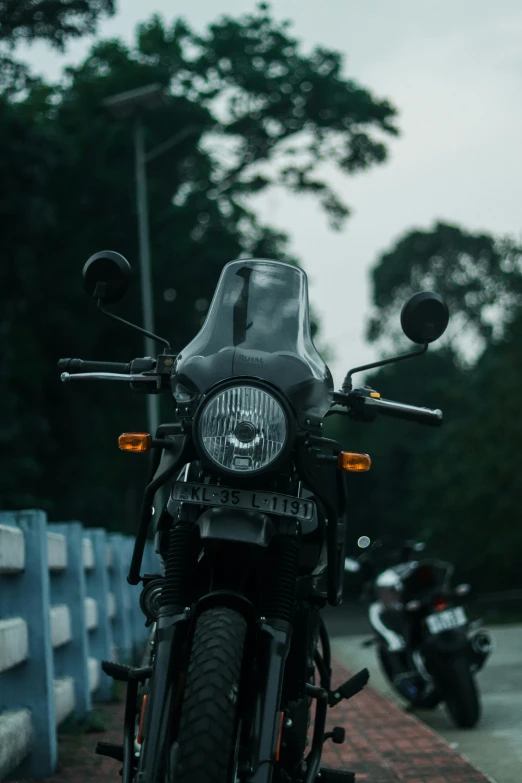 motorcycle with rear lights and side mirror sitting on the sidewalk