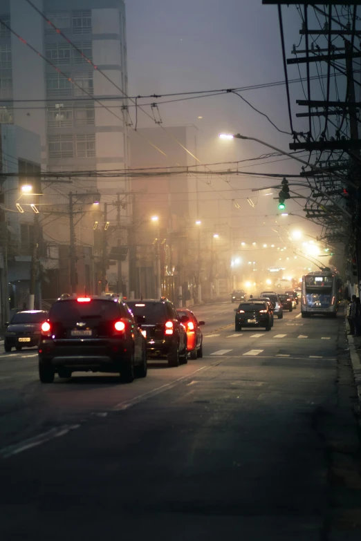 several cars driving on the road during the day