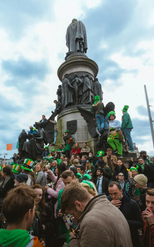 people at a festival with green and black hats