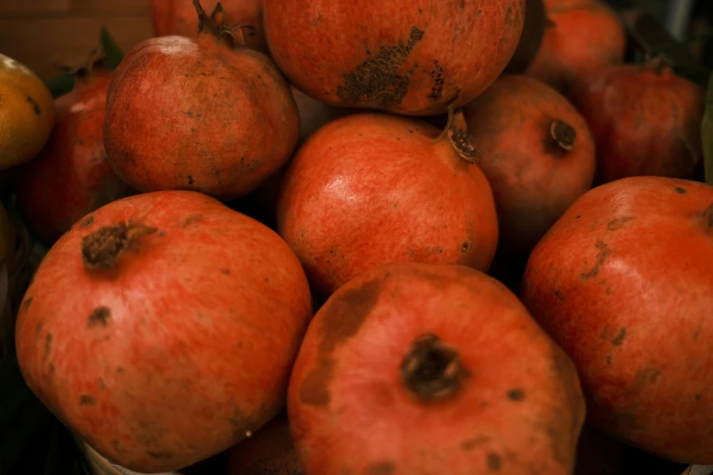 apples in a white dish on display with other fruit