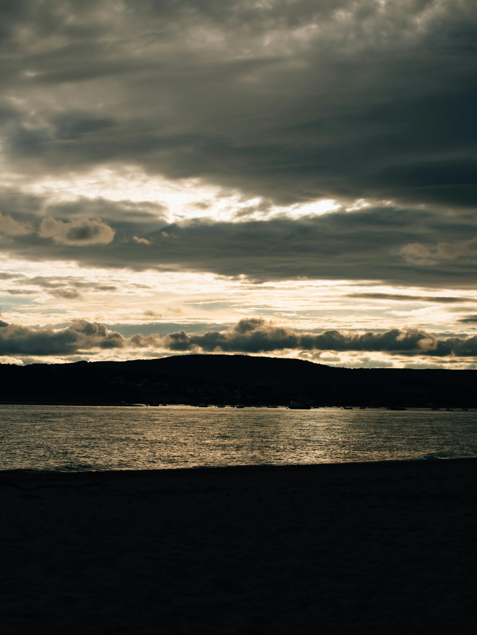 a black and white po of some water and clouds