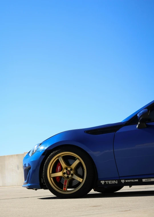 a blue sports car parked in the parking lot