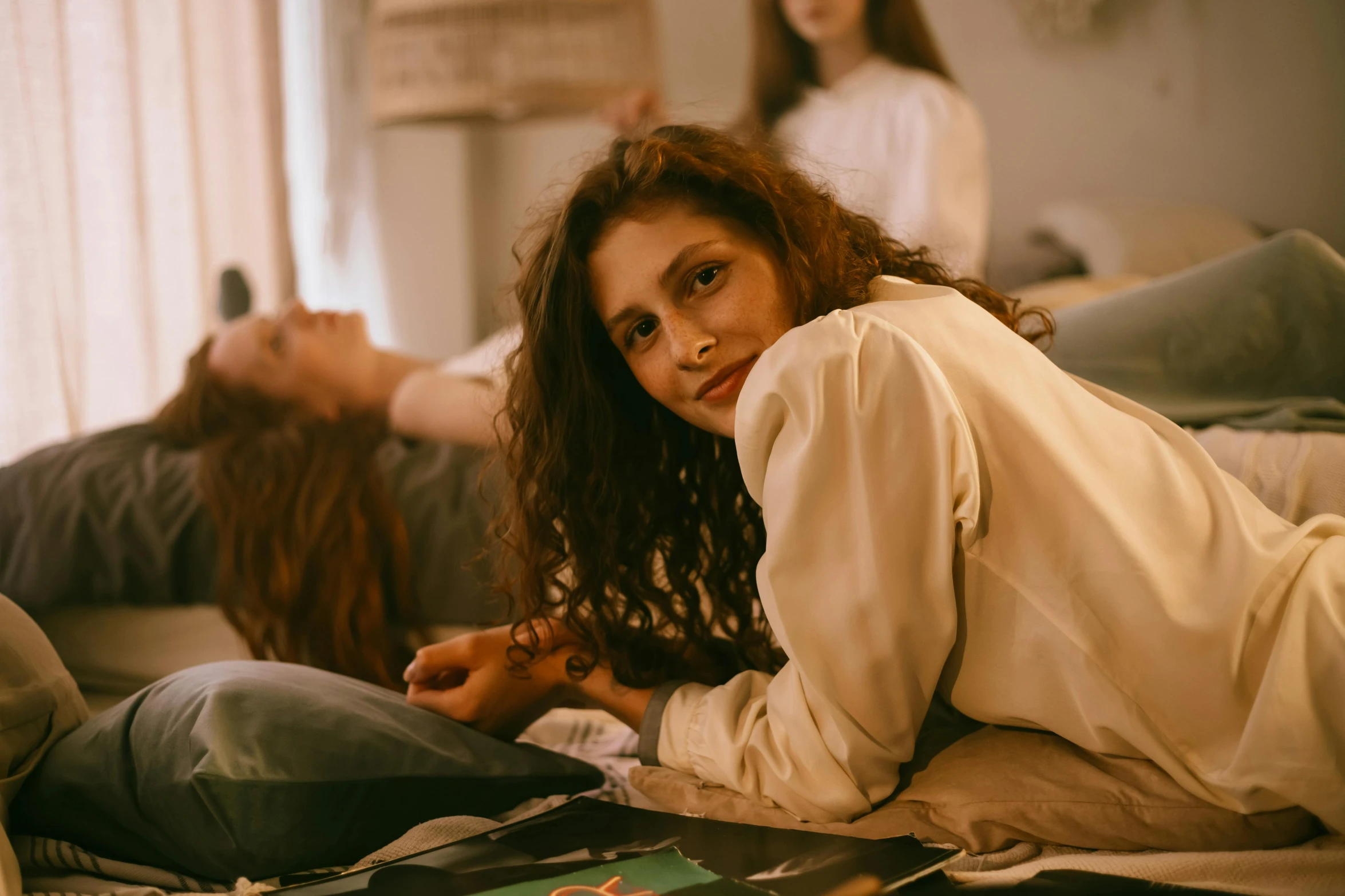 a women laying on the floor and another in a room