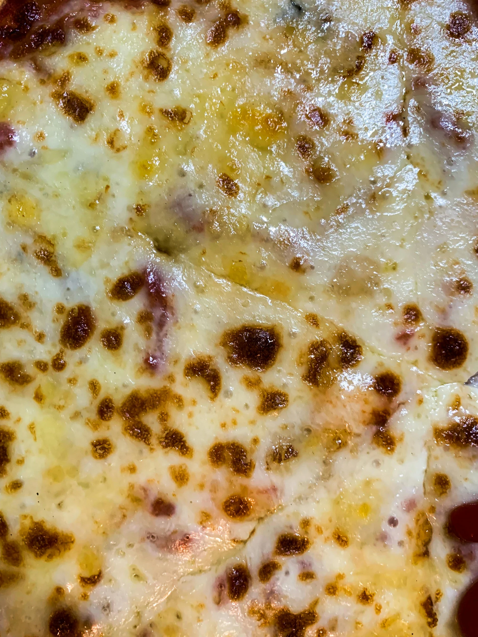 a pan filled with cheese covered in melted meat