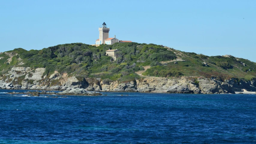 there is a small island surrounded by hills and cliffs