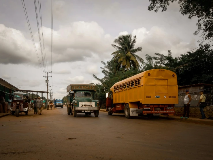 a large truck and bus on a small road