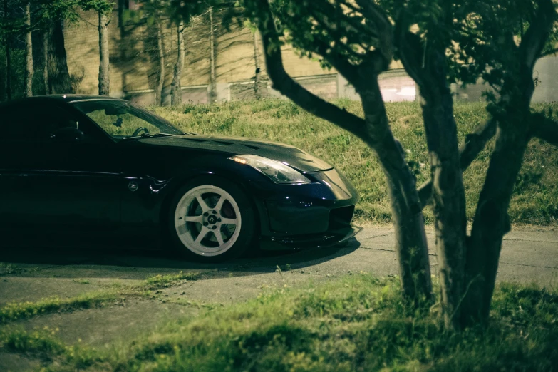 a black sports car parked on the side of a road