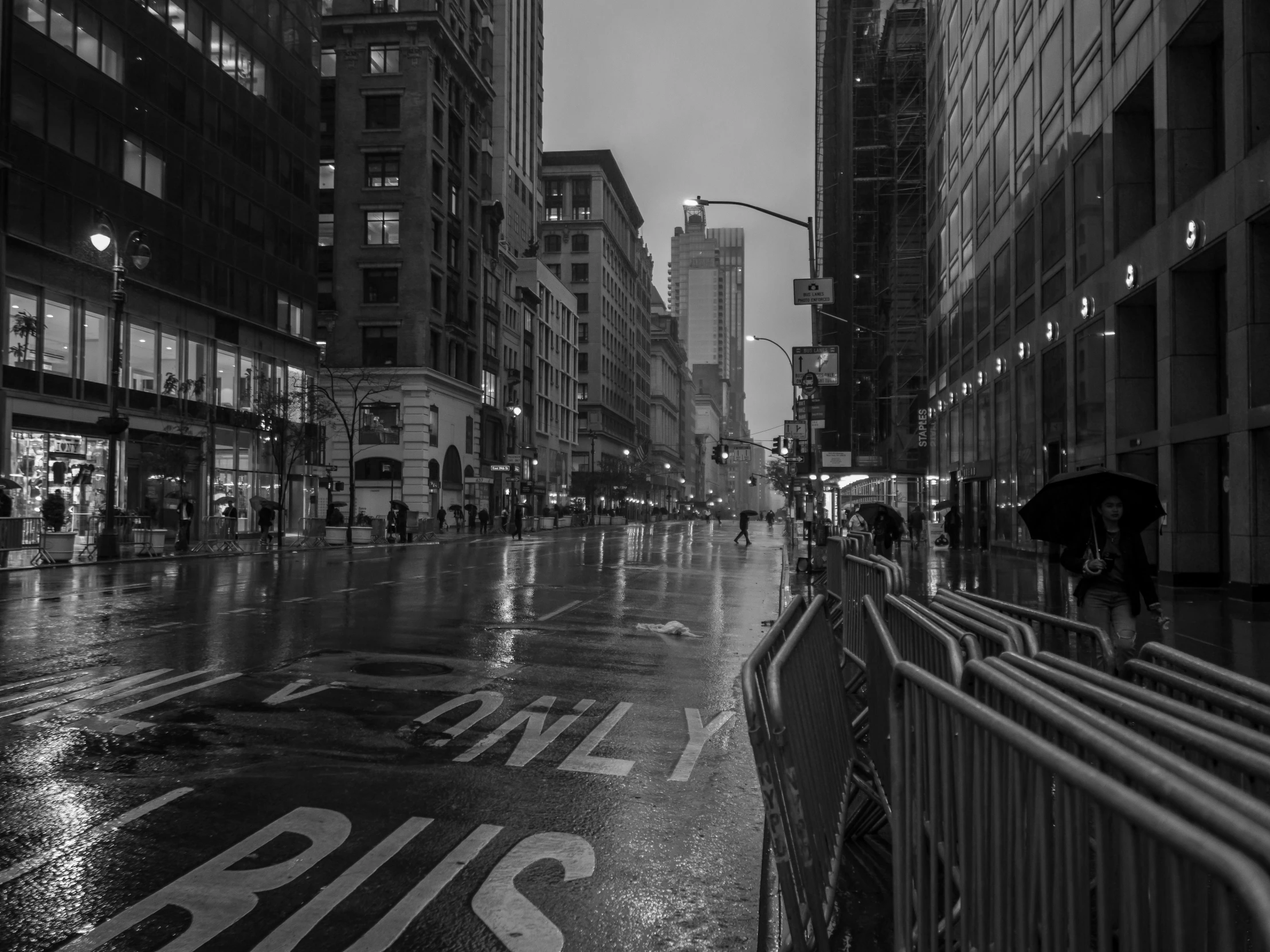 a couple of people with an umbrella walking on a wet street