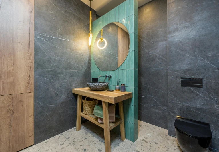 a mirror, sink and stool in a bathroom