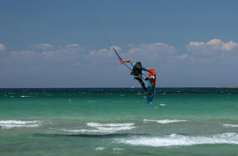 a para sailor flying over the ocean water