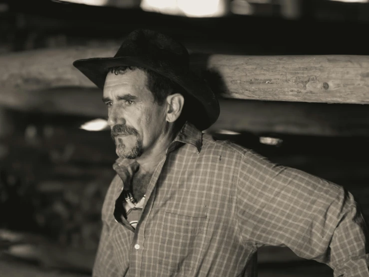 a man wearing a black hat and tie