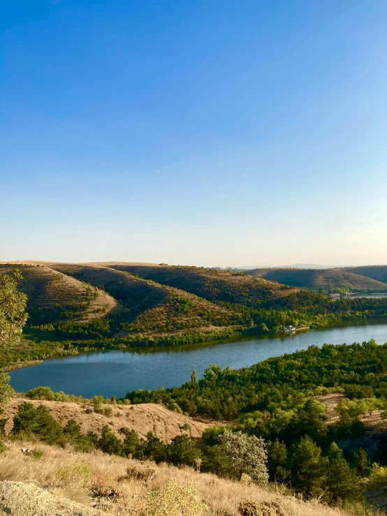 a view of a valley and a river that runs right next to it