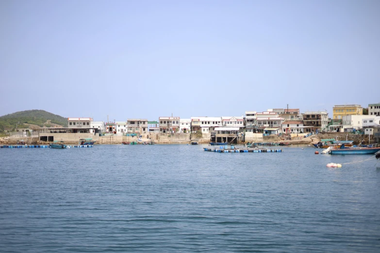 several boats are sitting at shore of the water