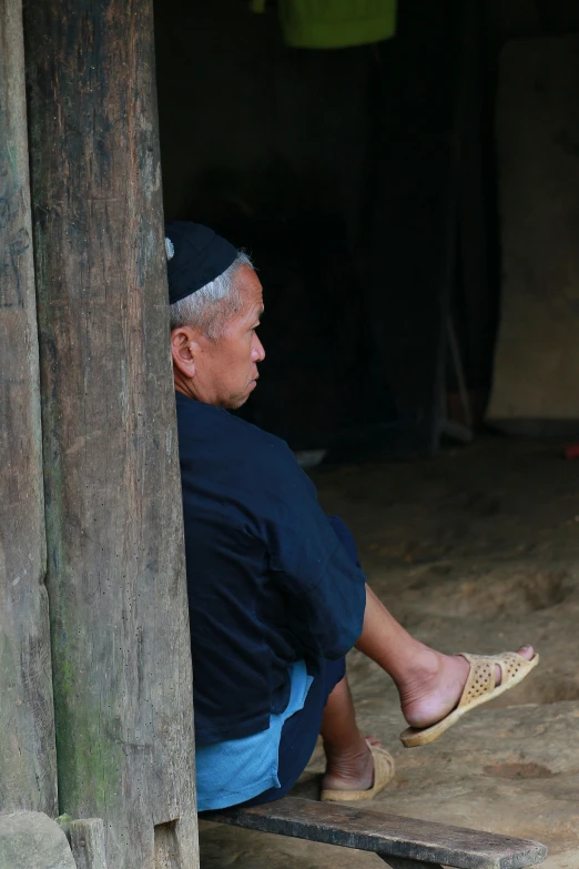 a older man sitting down with his shoes on