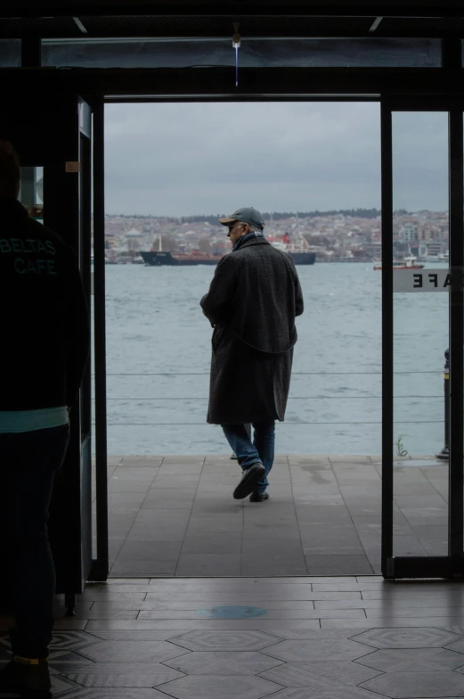 a man standing in front of two large doors