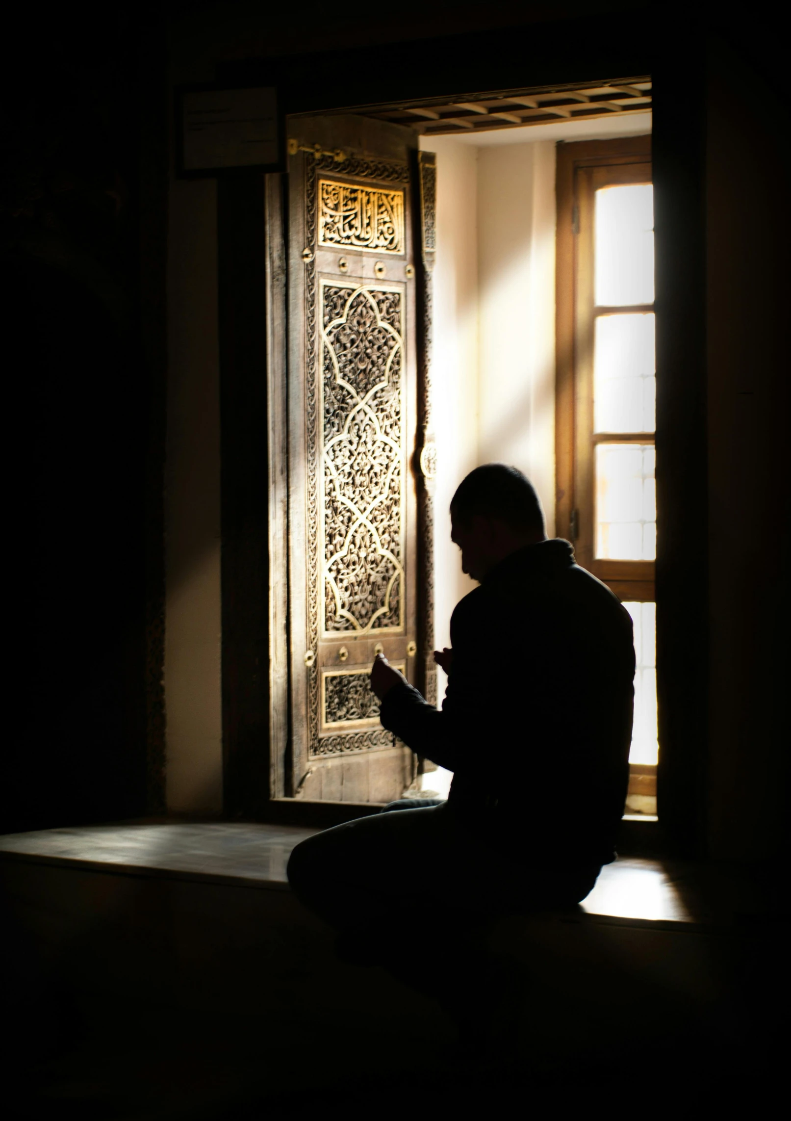 a man sitting on the floor in front of a door