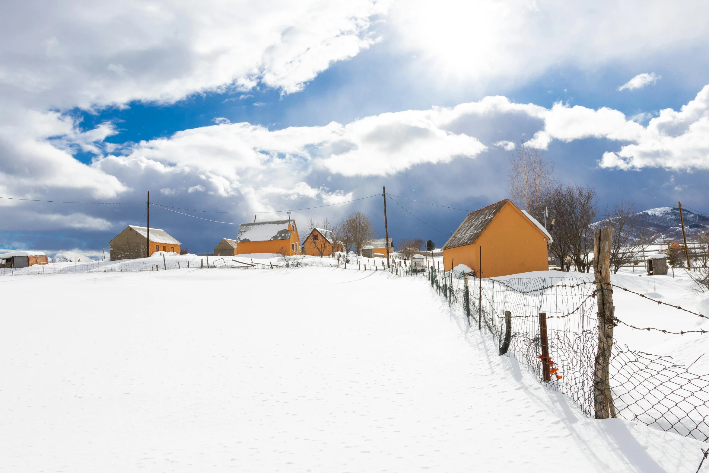 several houses and fences with snow on them