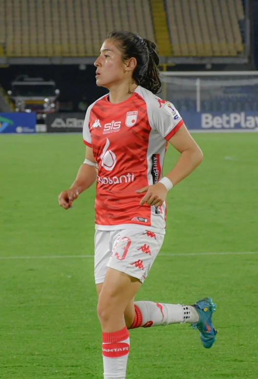 a female soccer player running with the ball
