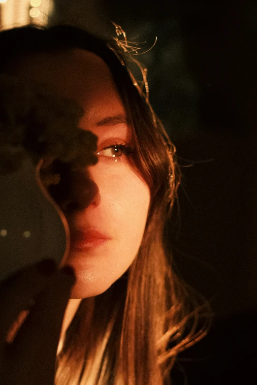 a woman in glasses holding a camera in front of her face