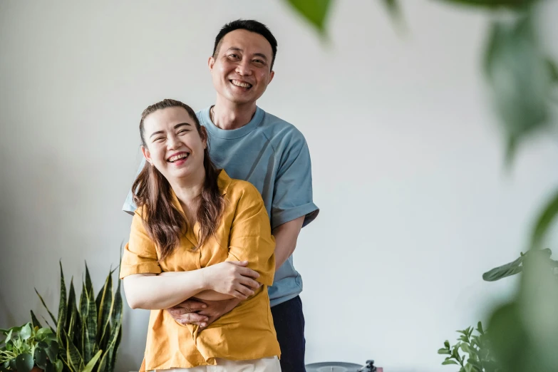 a smiling couple in front of their office space