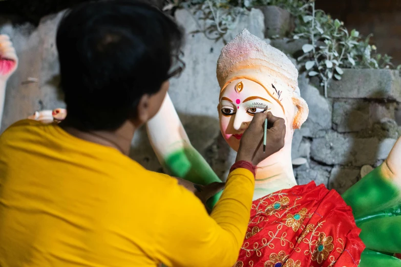 two women with painted faces and hands